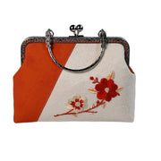 Acever A001 plum blossom embroidered kiss-lock clutch bag main product shot showing ivory and orange two-tone polyester body with red embroidered flowers and silver ornate frame on white background