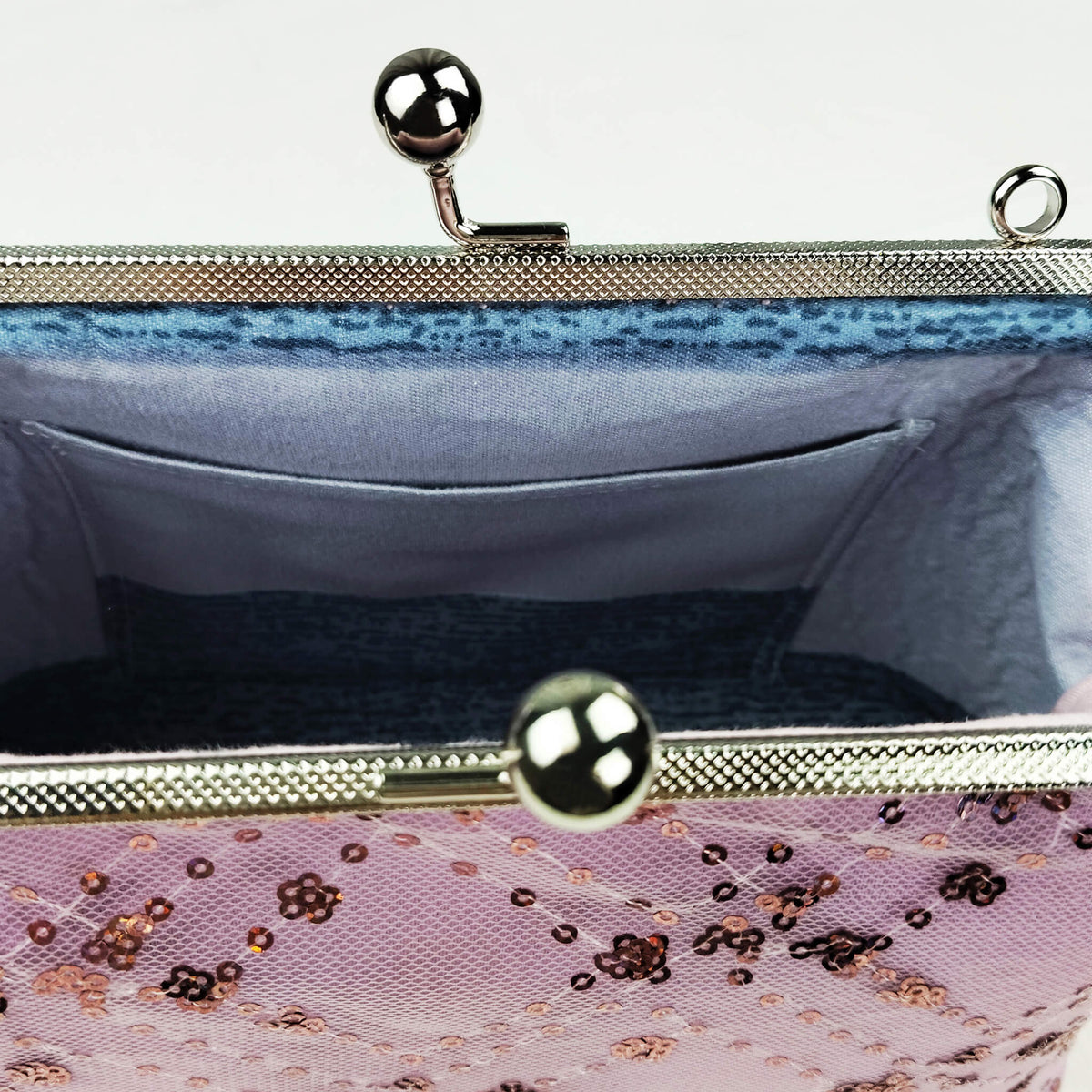 Close-up detail of Acever A005 clutch bag showing gunmetal ornate filigree kiss-lock frame with twin ball clasp side ring loops and gunmetal lobster clasp pearl strap connector
