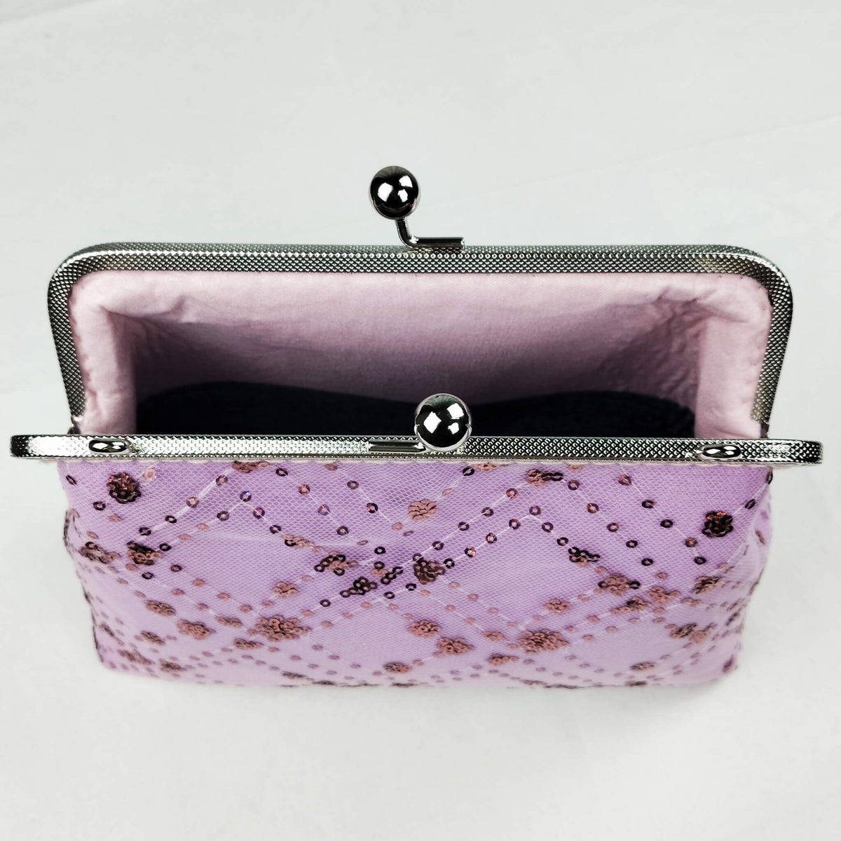 Interior view of Acever A005 sequin floral clutch bag open showing soft blush pink fabric lining with two-compartment design and secondary inner kiss-lock frame divider