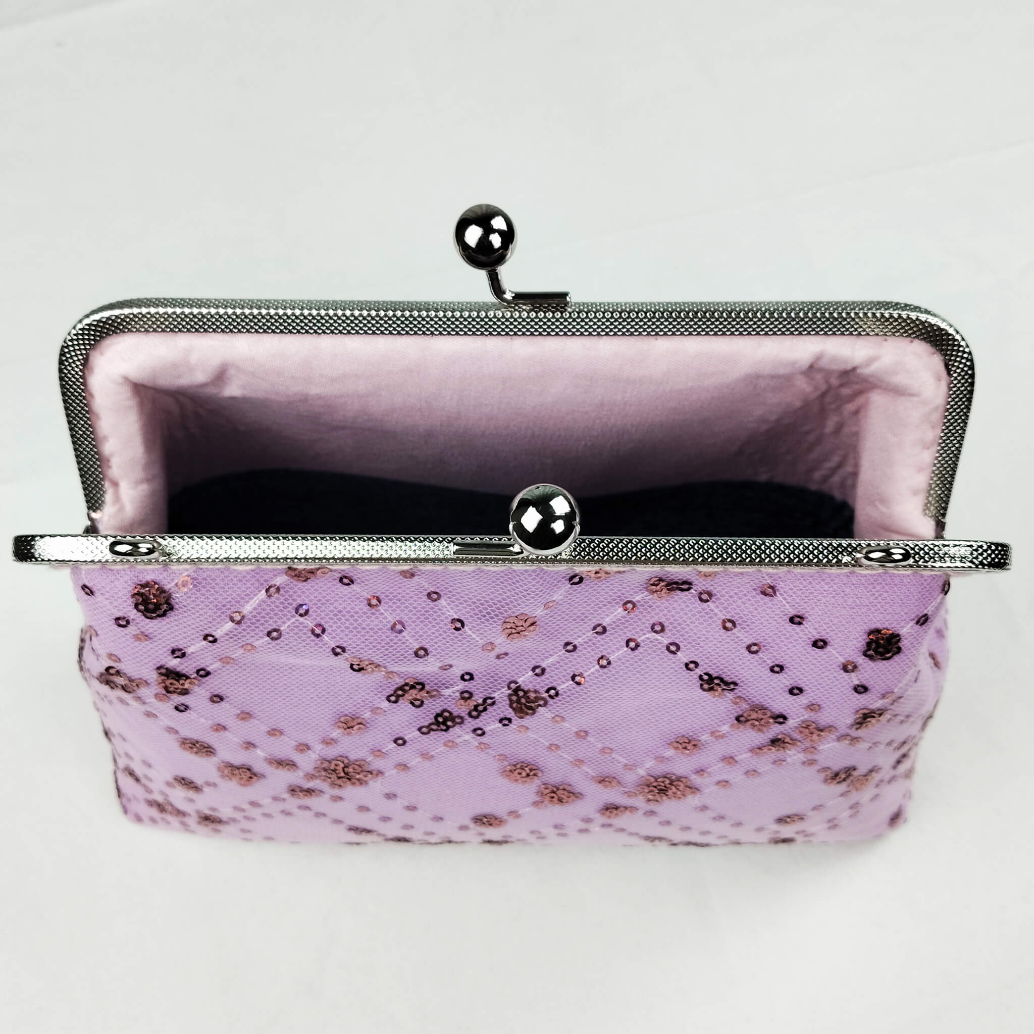 Interior view of Acever A005 sequin floral clutch bag open showing soft blush pink fabric lining with two-compartment design and secondary inner kiss-lock frame divider