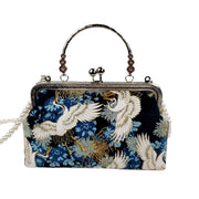 Acever A006 crane and chrysanthemum print kiss-lock top handle bag main product shot showing midnight navy polyester body with white cranes gold chrysanthemums blue peonies and silver ornate filigree frame on white background
