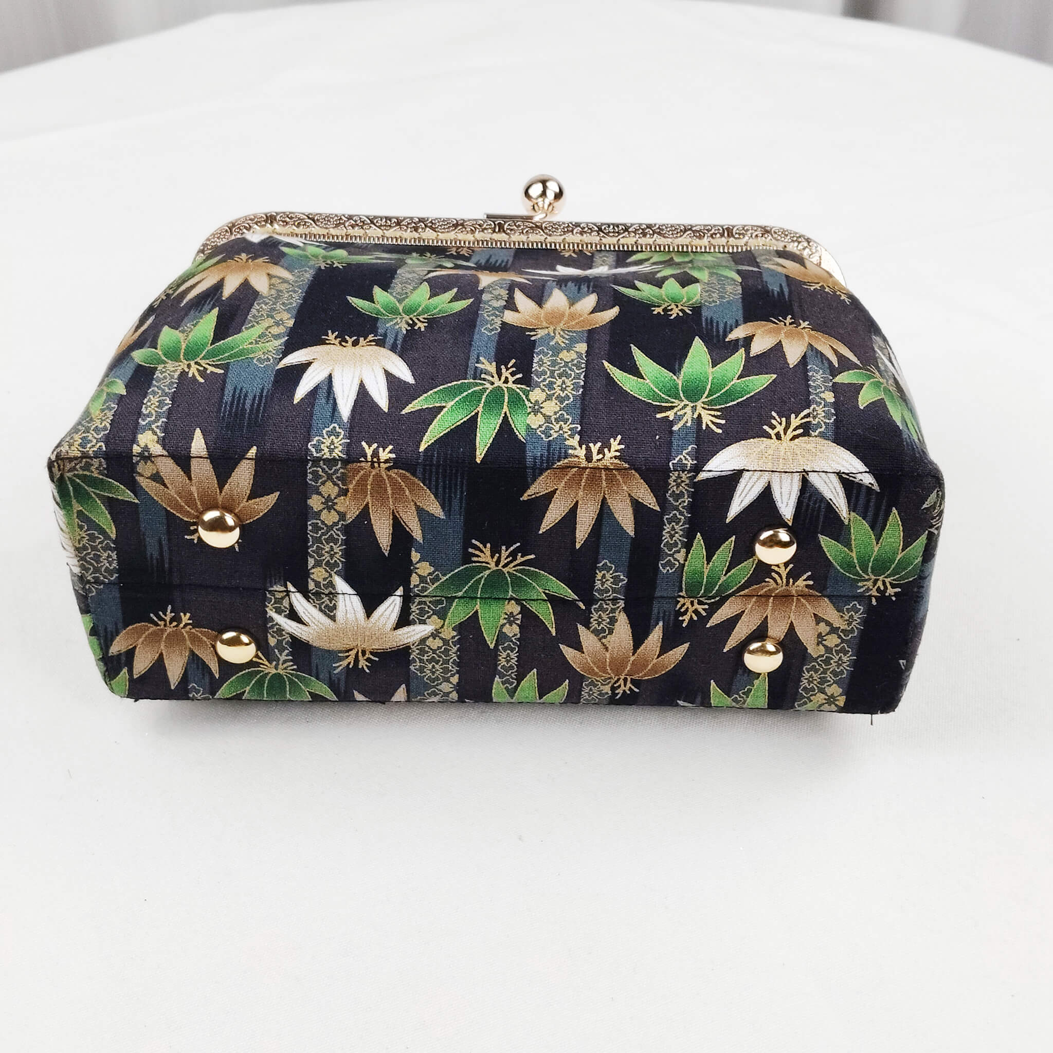 Bottom view of Acever B002 lotus and leaf jacquard clutch bag showing midnight navy jacquard base with lotus and leaf all-over print and metallic gold thread highlights