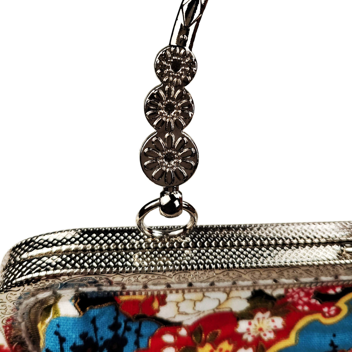 Close-up detail of Acever B003 bag showing vivid Japanese Nishiki brocade print with teal blue auspicious clouds golden honeycomb kikko red cherry blossoms sakura maple leaves momiji and seigaiha wave scales on black polyester fabric