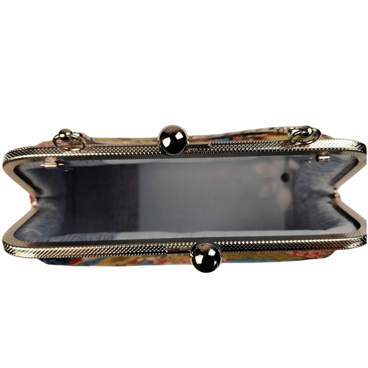 Interior view of Acever B003 Japanese Nishiki brocade bag open showing grey slate blue smooth fabric lining with single open compartment and antique silver frame edge