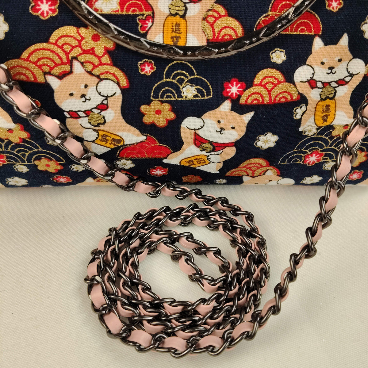 Close-up detail of Acever B005 bag showing gunmetal ornate filigree kiss-lock frame with twin ball clasp decorative top handle with triple crystal rhinestone bead connectors and blush pink woven flat-link chain crossbody strap with lobster clasp