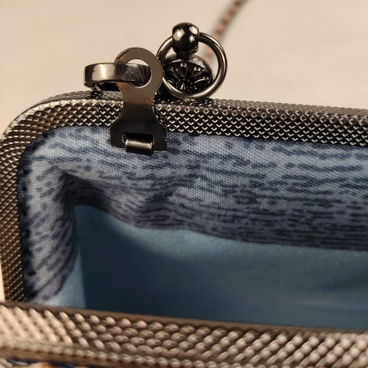Close-up detail of Acever B005 bag showing gunmetal textured zipper side detail and blush pink woven flat-link gunmetal chain strap with lobster clasp connector on Lucky Shiba Inu print fabric
