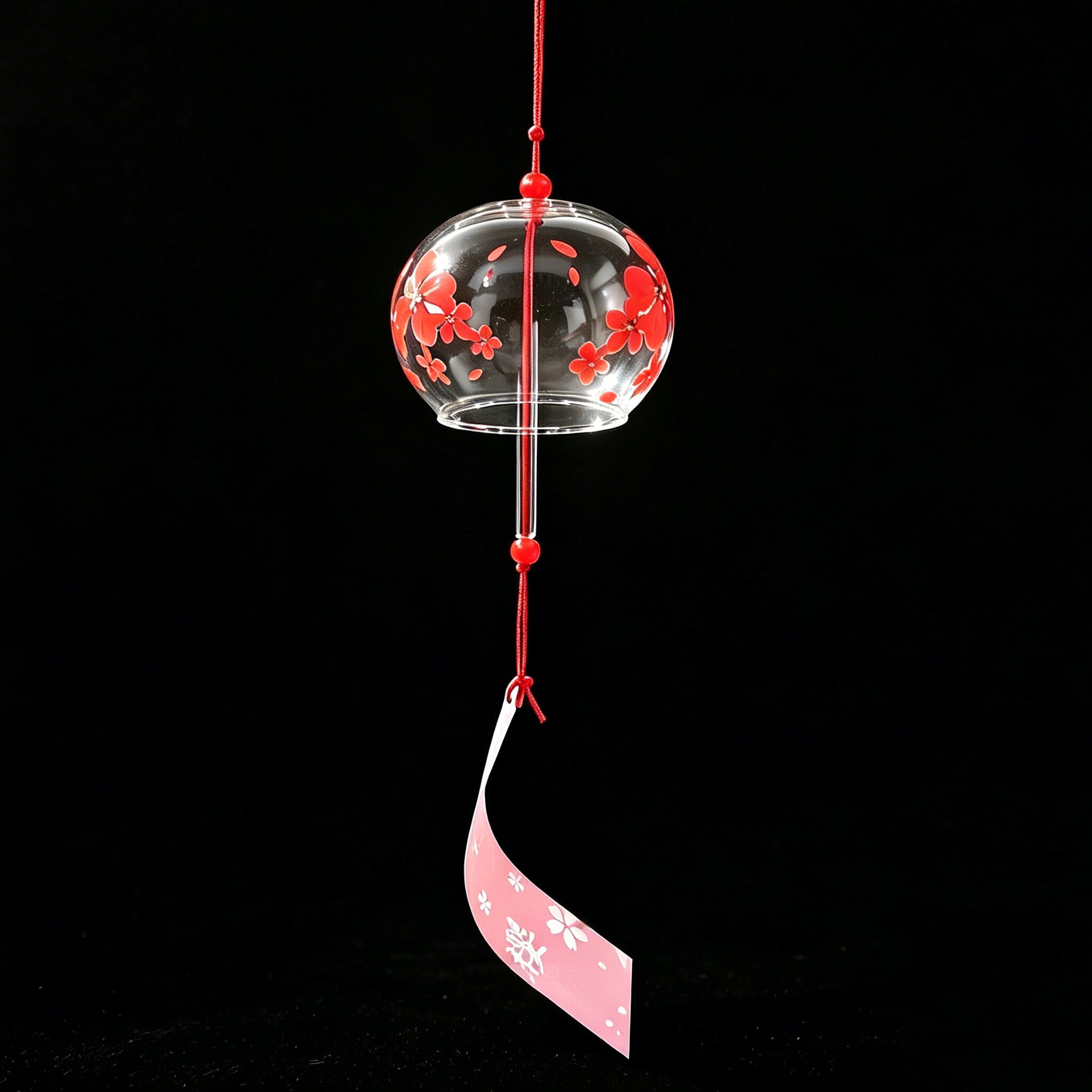 Acever red sakura glass wind chime X05 hanging with light shining on it with black background