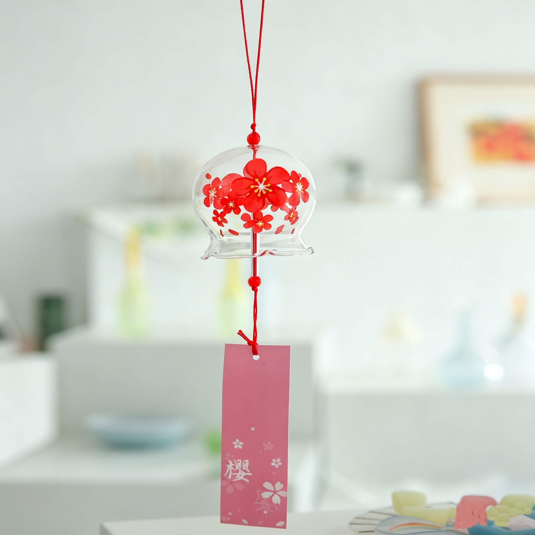 Acever red sakura waved-edge glass wind chime X06 hanging indoors in bright modern room showing full length with pink sakura wind tag