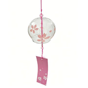 Product shot of Acever Japanese furin glass wind chime X09 with pink sakura blossoms on clear flat-rim globe and deep rose paper strip on white background