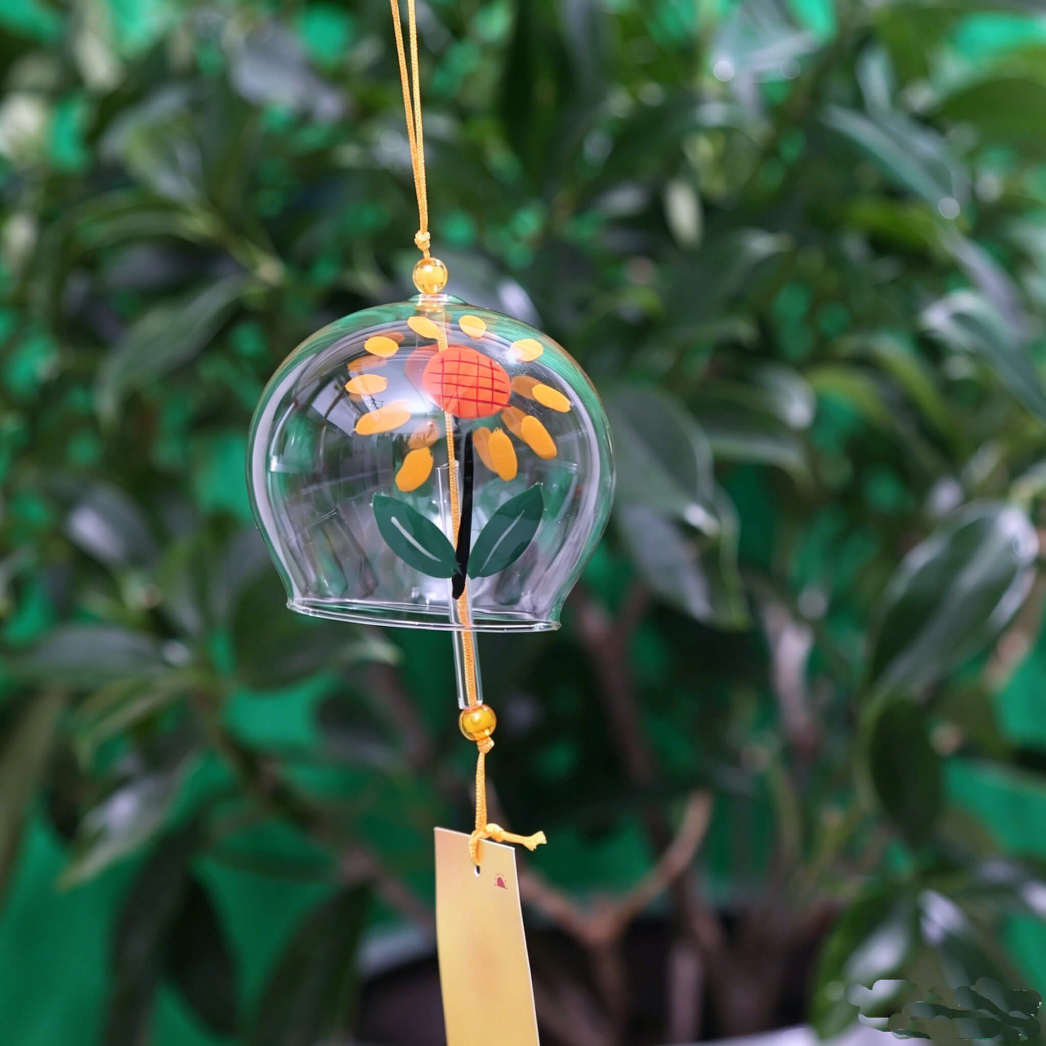 Acever sunflower glass wind chime X13 hanging from tree branch at night under full moon with golden sunflower paper strip swaying in breeze