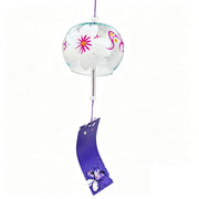 Main product shot of Acever Japanese furin glass wind chime X28 on white background showing clear globe with white magnolia blossoms and magenta vine scrolls with deep violet iris paper strip