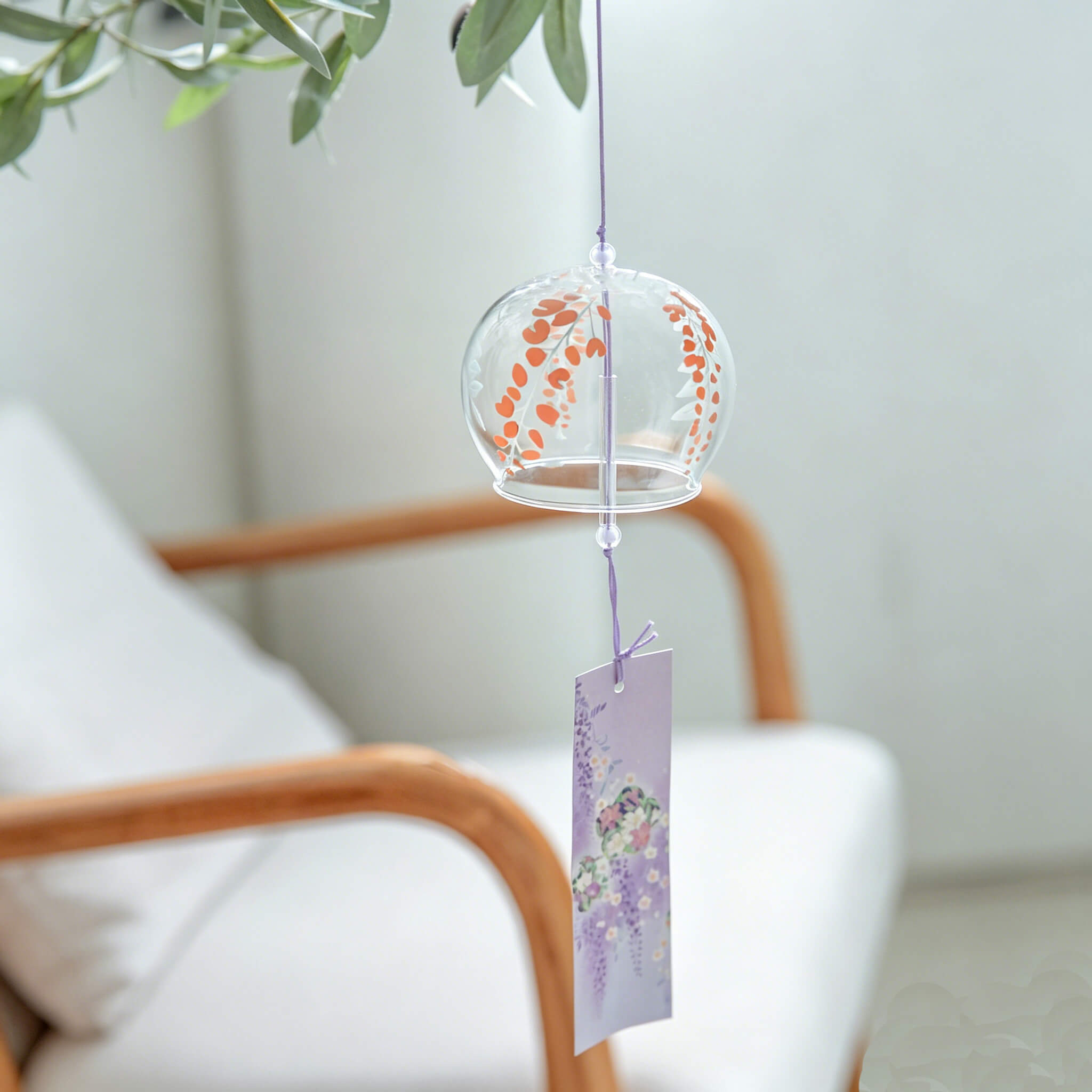 Acever purple wisteria glass wind chime X30 on cream background showing full length with clear globe, burgundy wisteria petal clusters, green fern fronds, and lavender wisteria paper strip