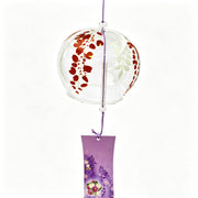 Close-up of Acever purple wisteria glass wind chime X30 on white background showing clear globe with cascading burgundy wisteria petal clusters and lavender paper strip with purple wisteria and floral wreath