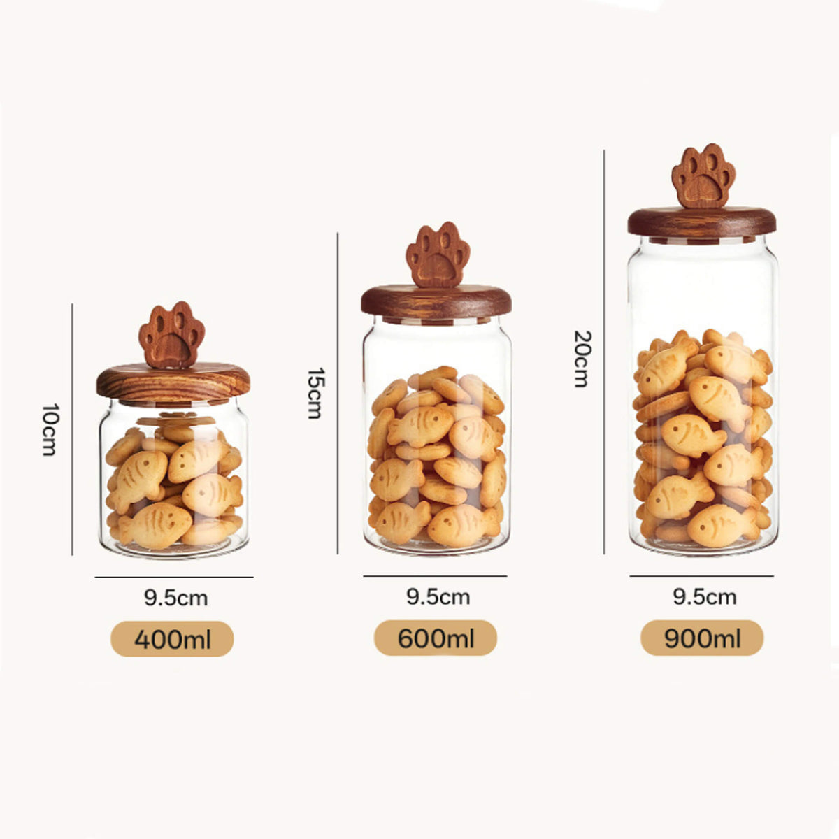 Three sizes of smooth glass jars with cat paw handles filled with fish-shaped biscuits labeled 400ml, 600ml, and 900ml with dimensions.