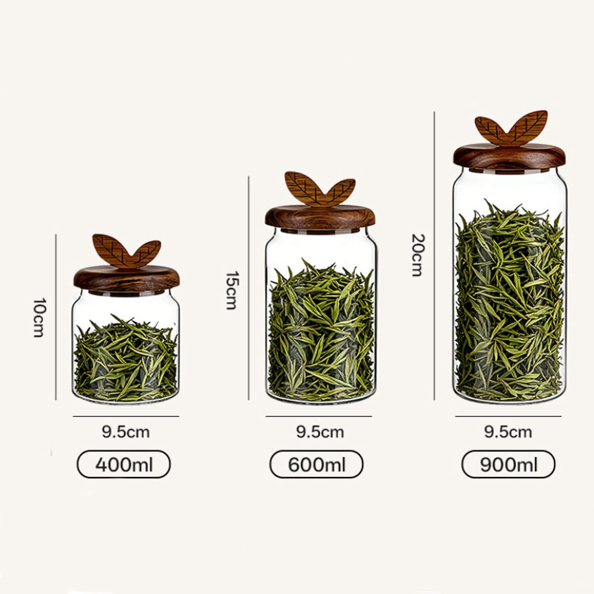 Three sizes of smooth glass jars with leaf handles filled with green tea leaves labeled 400ml, 600ml, and 900ml with dimensions.