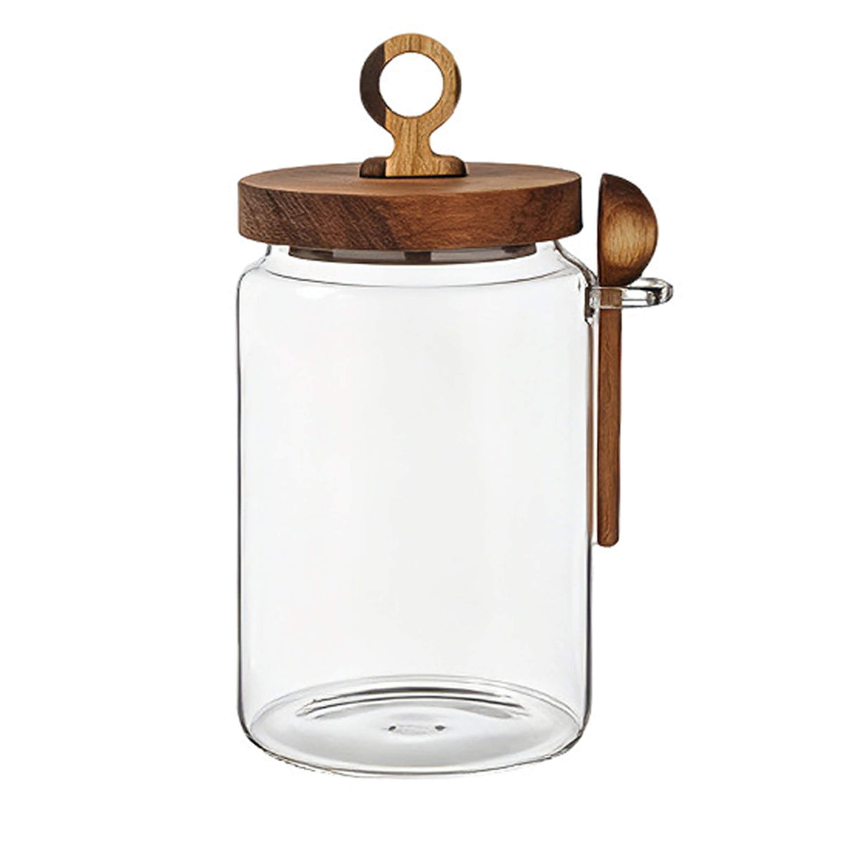 Clear smooth glass jar with round wooden lid, ring handle, and wooden spoon resting in glass side holder.