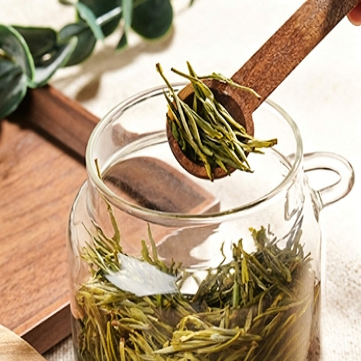 Wide-mouth smooth glass jar opening with coffee beans falling inside.