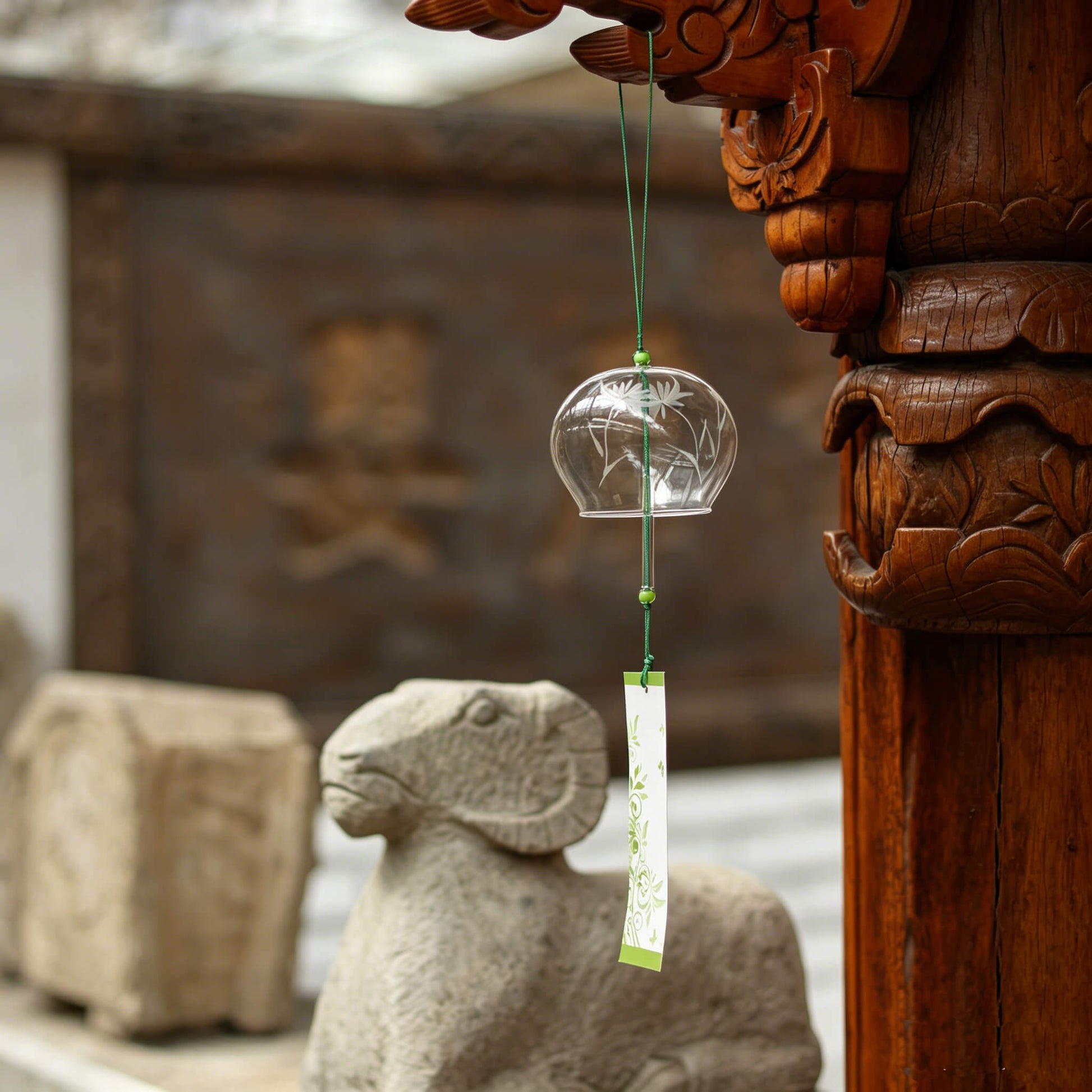 Acever white chrysanthemum glass wind chime X32 hanging from traditional Chinese temple carved wooden pillar with stone ram sculpture showing clear globe with white lotus and green paper strip