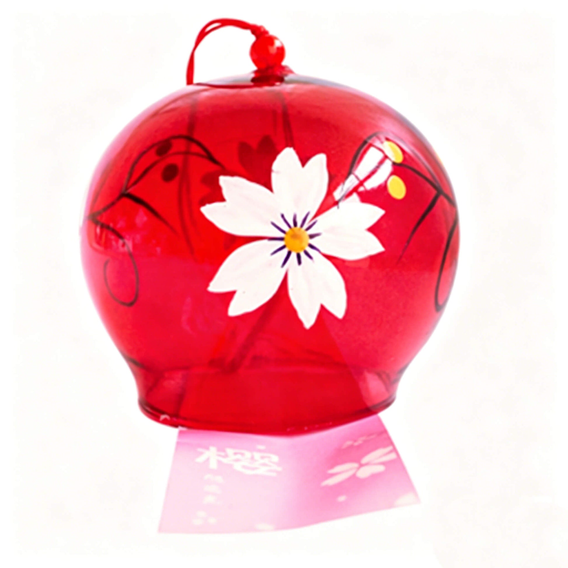 Close-up of Acever ruby red sakura glass wind chime X38 on white background showing deep crimson tinted globe with large white sakura bloom, black detail lines, golden centre, and navy vine scrolls